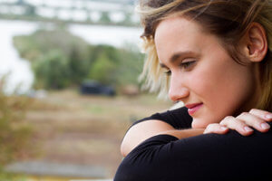 A woman smiles while strongly considered drug rehab south florida